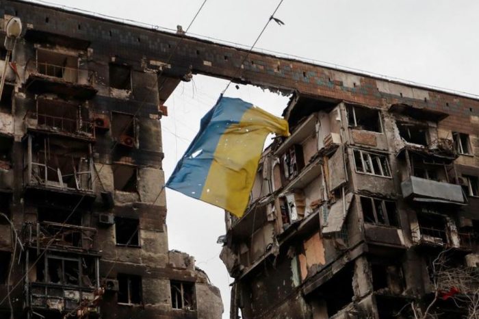 A view shows a torn flag of Ukraine hung on a wire in front a destroyed apartment building in Mariupol, April 14. REUTERS/Alexander Ermochenko